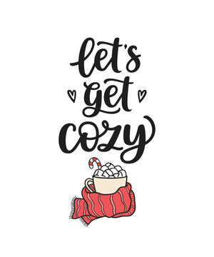 Lets get cozy hand lettering and cup full of marshmallows wrapped in scarf. Winter vibes, hygge lifestyle concept