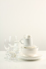 Beautiful White bright ceramic bowl and tarenes on the table. Clean crockery concept