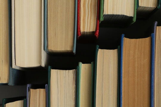 Open book, hardback colorful books on table. Back to school. Copy space for text. Education business concept