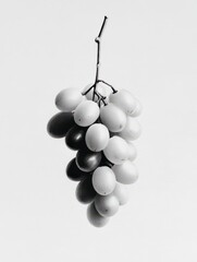 Grape Delight: A monochromatic display of plump, juicy grapes hanging from a slender stem, showcasing a perfect blend of natural beauty and culinary allure. 