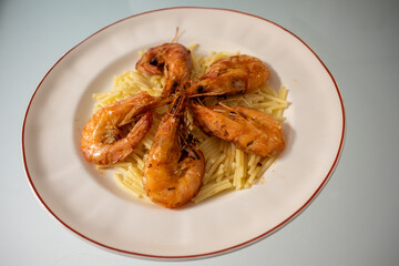 Fried shrimps and langoustines on a plate. Close-up of fried shrimps and langoustines.
