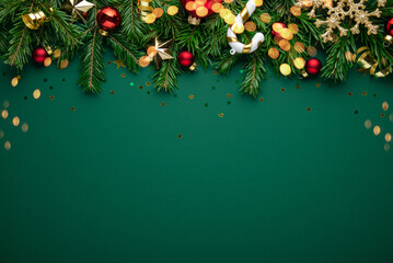 Christmas background with xmas tree, christmas decoration and sparkle bokeh lights on green...