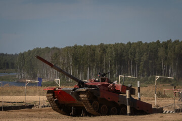 Fototapeta premium Tank Maneuvering in Training Exercise on Rugged Terrain