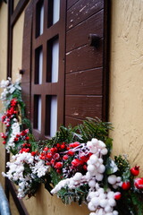 Beautiful Christmas and New Years windows decoration. Festive Christmas decorations and ornaments on the wooden windows