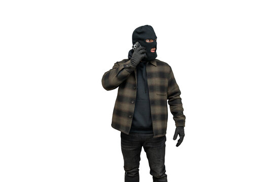 Criminal wearing balaclava speaking on smartphone for bank robbery plan on transparent background