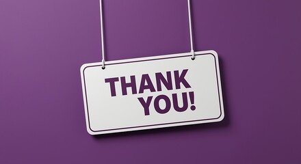 A white sign with thank you text hanging on a purple background