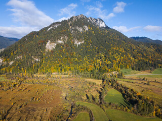 Ettaler Weidmoos wetland below the Laber and Ettaler Mandl near Oberammergau, vibrant autumn colors and clear sky from an aerial view, ideal for travel ads.