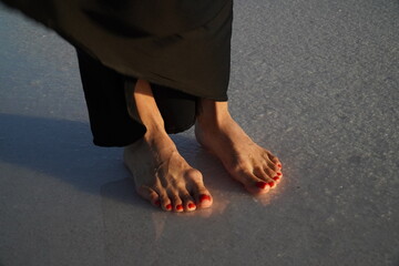 A view of women's feet near the water on a salt lake