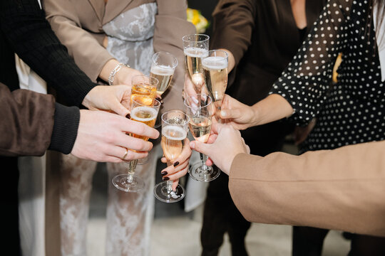 Group of people toasting with champagne glasses at festive celebration or corporate event