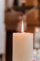 Burning candle flame symbolizing faith, prayer, and remembrance in warm soft light