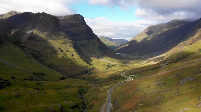 Scenic drone view of a road winding through highlands in Scotland near Glencoe