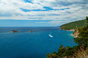 View from top of cliff to beautiful Adriatic seascape near Petrovac, Montenegro. Beautiful coast, rock, and island in sea