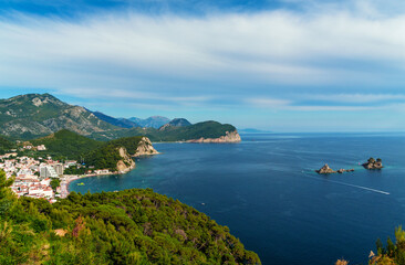 Obraz premium Top view of beautiful seascape and panorama of Petrovac city, Montenegro. Beautiful coast, city architecture and beach, islands. Yachts in the Adriatic Sea