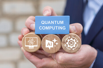 Person holding blocks with icons sees the words QUANTUM COMPUTING. Quantum computingcpncept, Quantum computer qubit information technology.