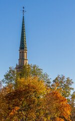 Beautiful fall foliage and the spire of the First Baptist Church of Denver in downtown Denver, Colorado