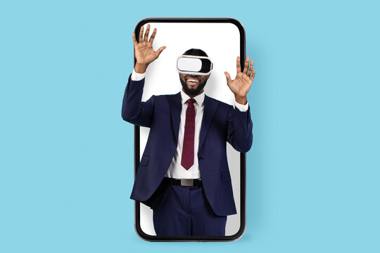 Digital Entertainment. Black Businessman In Vr Glasses Looking Out Of Big Smartphone, Excited Young African American Male Entrepreneur Enjoying Virtual Reality Experience, Collage, Copy Space - Powered by Adobe