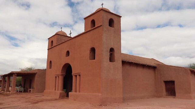 Neoclassical facade of the historic Nuestra Senora de Andacollo Church in La Falda, Catamarca. Twin towers and adobe construction on the Adobe Route