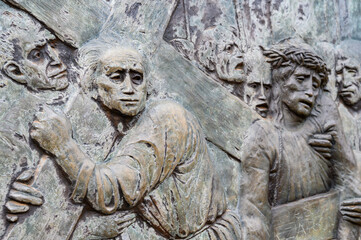 Station V: Simon of Cyrene helps Jesus carry the Cross. The Way of the Cross on Mount Križevac (the Cross Mountain) in Medjugorje.