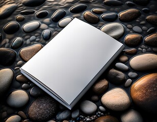 A blank book amidst polished river stones, a place to capture nature's inspiration for stories untold.