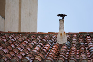 Ventilation pipe on an old tiled roof.