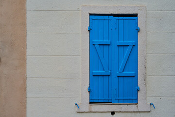 Blue wooden shutters on the window.