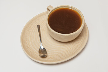 Oat coffee with plant-based milk and creamy foam in a sustainable cup with nature-inspired motifs and an ergonomic handle