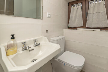 Nordic bathroom with a freestanding shower, a transparent glass screen, and walls clad in white hexagonal tiles