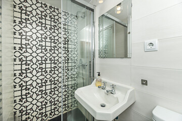 Modern bathroom with frameless glass shower, sliding shower screen, and gray marble porcelain tile...
