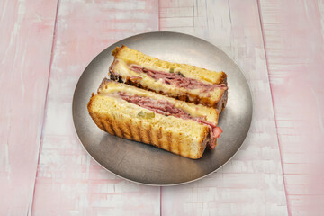 Croque monsieur sandwich with York ham, melted Emmental cheese, and béchamel sauce between toasted sandwich bread