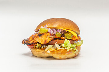 Beef burger with burrata, cherry tomato, and purple basil on crystal bread