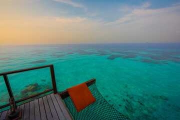 Tranquil closeup calm sea water waves with palm trees. Hammock near Ocean. Tropical island beach landscape exotic shore coast. Summer vacation, holiday amazing nature. Relax paradise, Maldives.