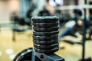 Gym weight stack closeup. Vertical stack of gym weight plates used for strength training.