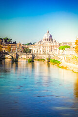 Fototapeta premium St. Peter's cathedral over bridge and river water in Rome, Italy