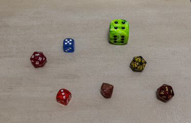 dice including classic six-sided and polyhedral gaming dice arranged on a light surface. Symbolic composition representing randomness, probability, gaming, and decision-making  or role-playing games