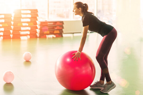 Woman at the gym doing exercises with pilates ball - Powered by Adobe