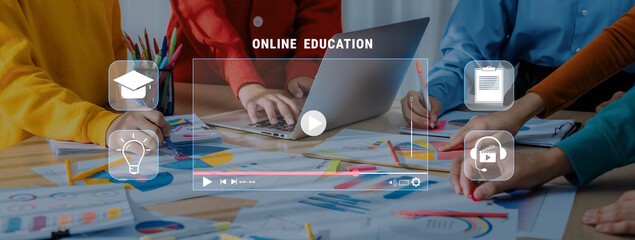 A diverse group engages in a collaborative online education project, utilizing technology and creative materials in a modern workspace to foster learning and innovation. Trope