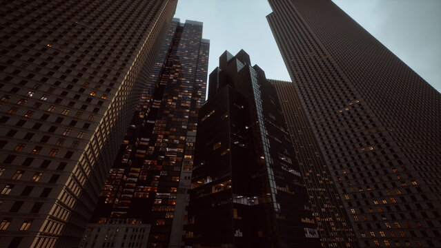 As dusk settles, tall skyscrapers loom against the twilight sky. Their windows shimmer with warm light, creating a striking contrast to the darkening surroundings.