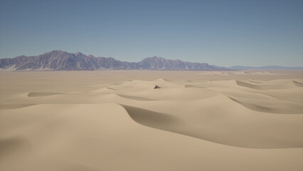 A stunning view captures the undulating sand dunes stretching far into the horizon. The sun shines brightly over the serene landscape, with mountains looming in the distance.