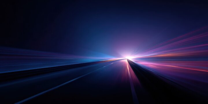 Abstract light trails speed down a dark road toward a bright center.