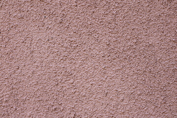 Soft pink wall texture with rough stucco surface for background and design projects