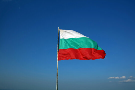 Bulgarian flag in the wind against a blue sky