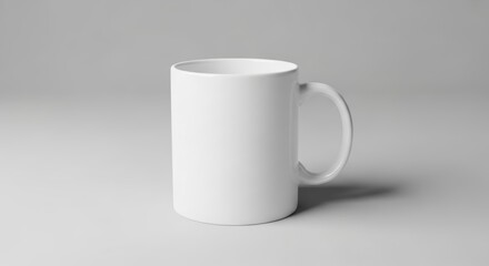 Obraz premium Minimalist white mug on plain background for mockups and branding design
