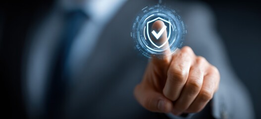 Businessman finger touches glowing digital shield icon for security concept.
