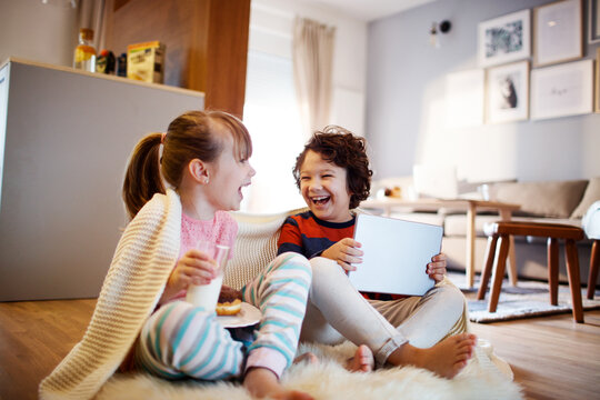 Young children laughing together indoors