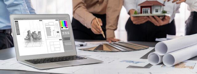 Group of interior architect designer discussing together on blueprint and laptop screen display...
