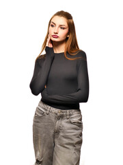 A young woman with long brown hair and a black shirt and jeans white background. Fashion and beauty. Stunning teenager model with slim athletic body type.