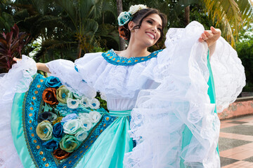 Portrait of a happy Hispanic woman dancer in a traditional dress in Neiva, Huila, Colombia. Concept of Colombian culture
