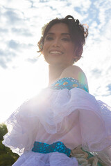 Portrait of a smiling Colombian dancer in a traditional dress in Neiva, Huila, Colombia. Concept of Colombian culture and happiness
