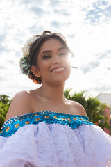 Portrait of a smiling Hispanic woman dancer in a traditional dress in Neiva, Huila, Colombia. Concept of Colombian culture and dental health
