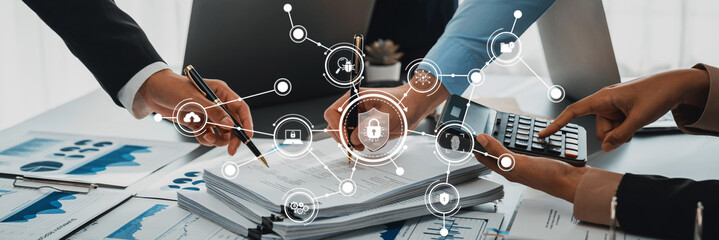 A collaborative team engages in analyzing security solutions and financial data in a modern office, showcasing digital icons representing various security measures and trends. Amity